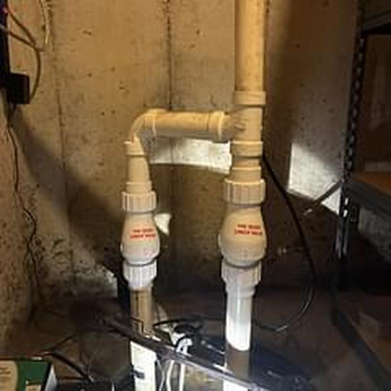 PVC sump pump discharge line with check valves