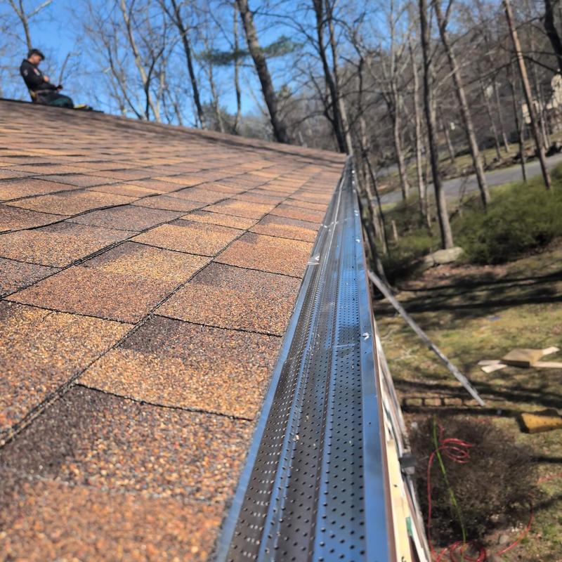 Gutter guards on shingle roof in wooded area Gutter guards on shingle roof in wooded area