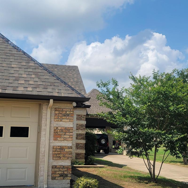 Roof shingles with hail damage on residential house