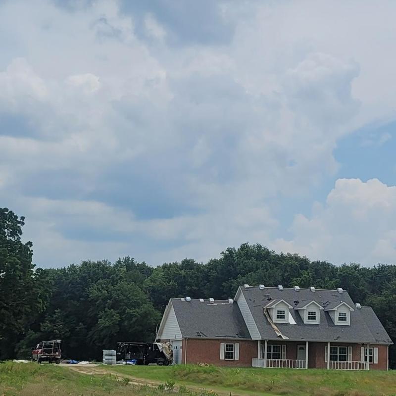 Asphalt shingle roof with visible hail damage