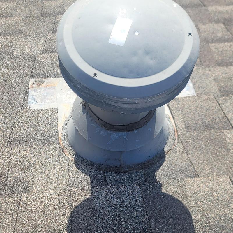 Roof vent with hail damage on asphalt shingles
