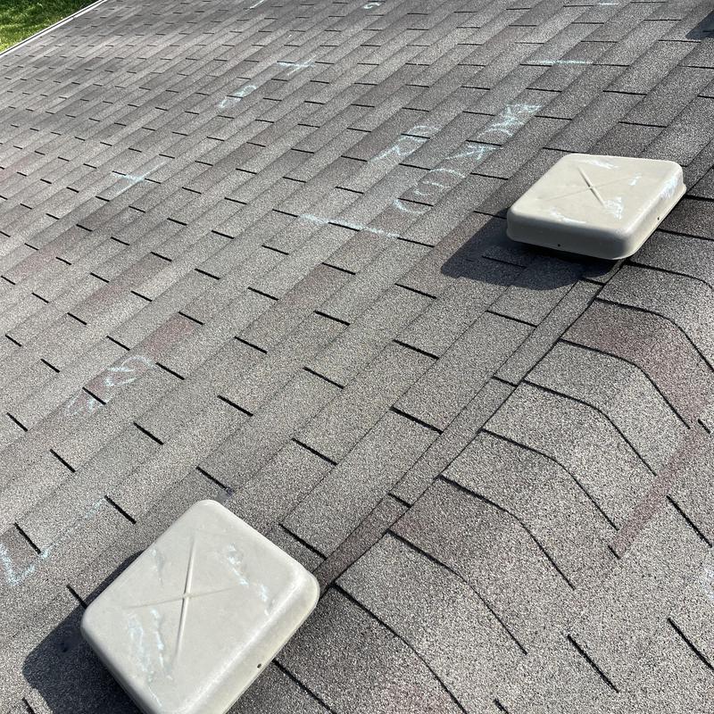 Asphalt shingle roof with vent caps and chalk markings
