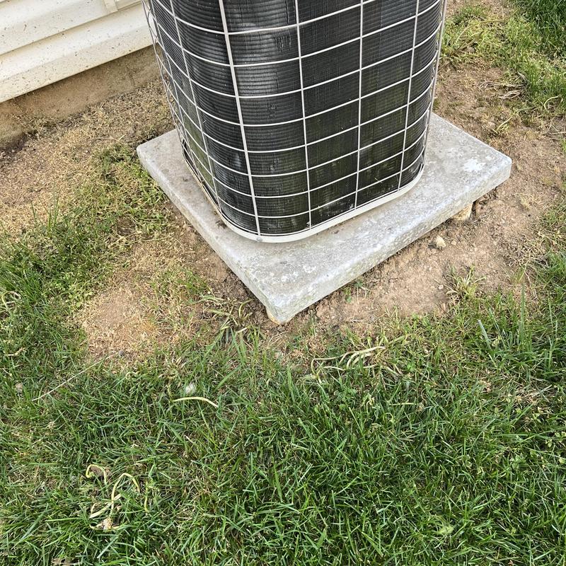 Air conditioner outdoor unit on concrete pad