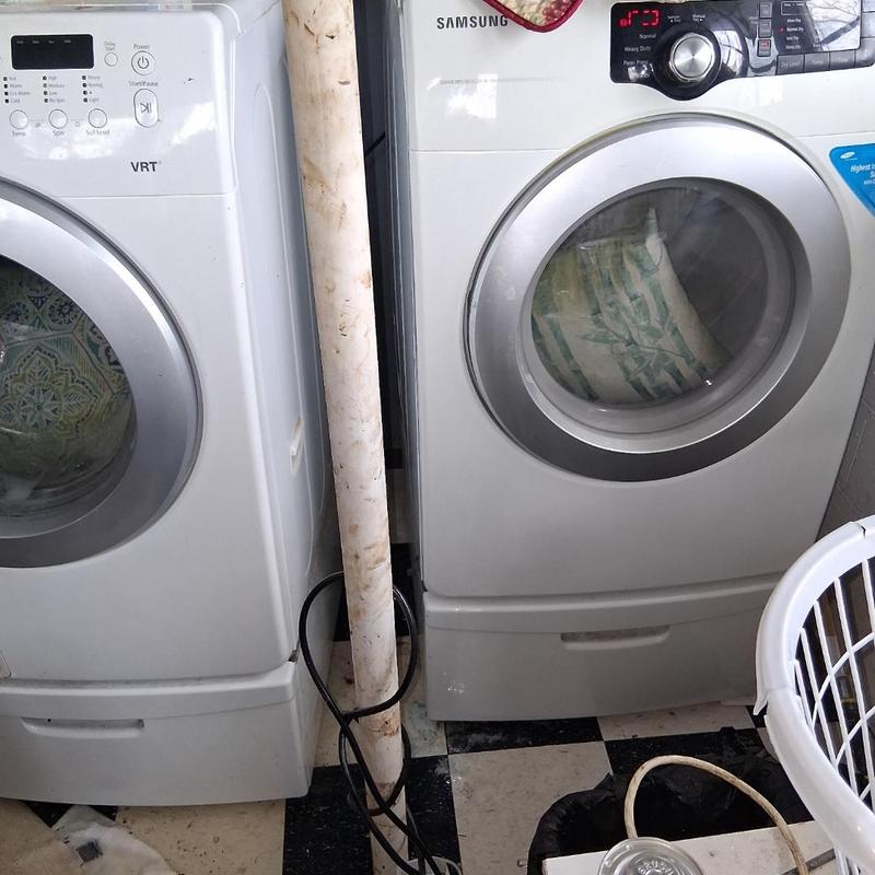 Front load washing machines side by side in laundry room