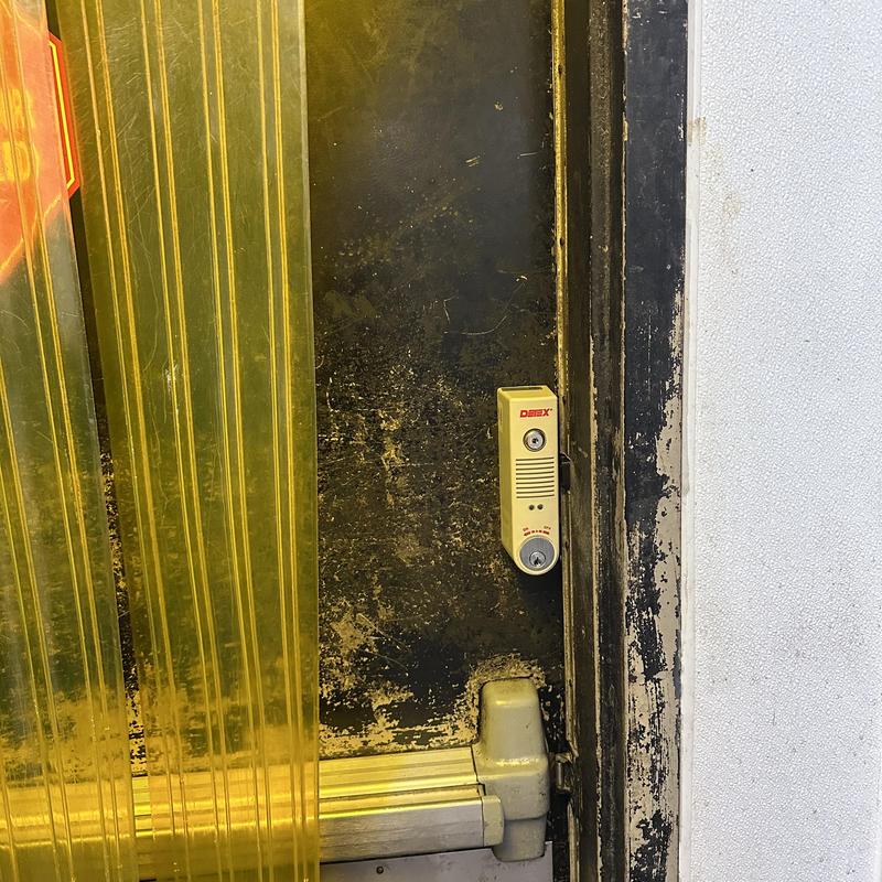 Detex alarm exit device on back door with lock