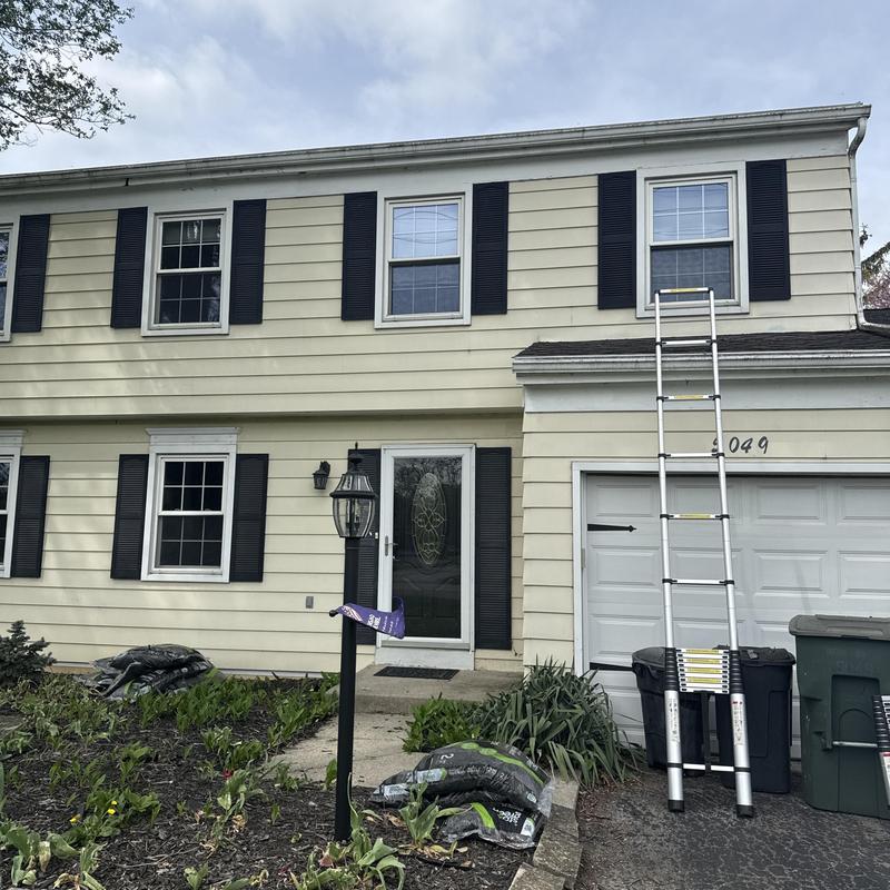 Roof inspection with ladder at suburban home in Ohio