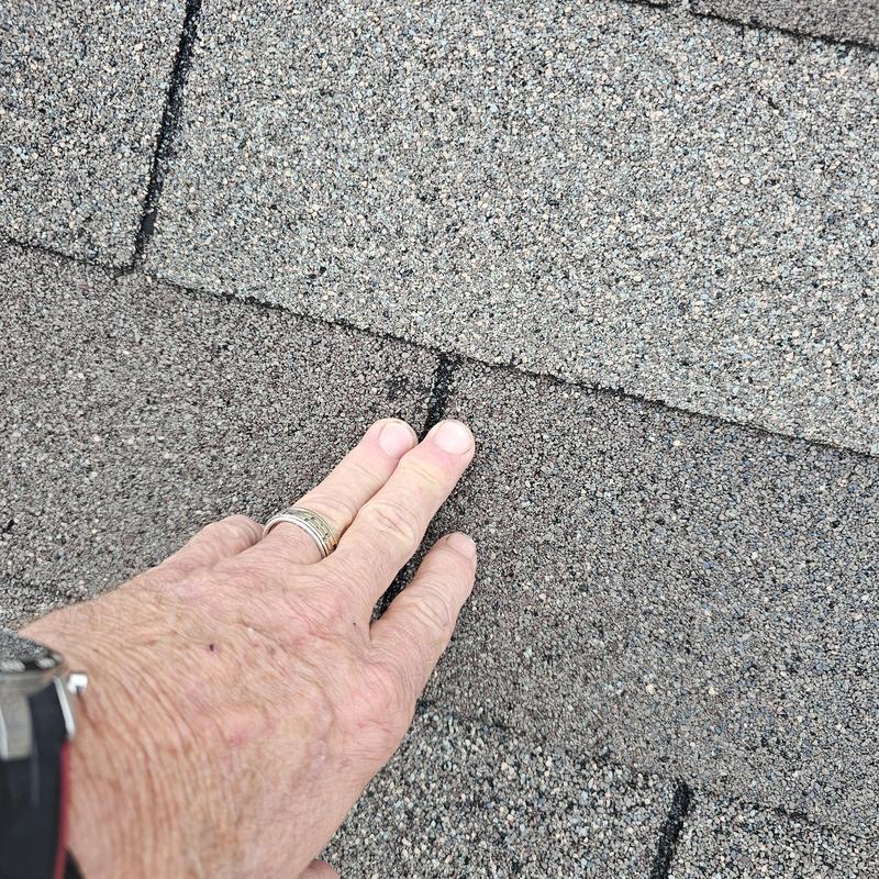 Asphalt roof shingles with hail damage close-up