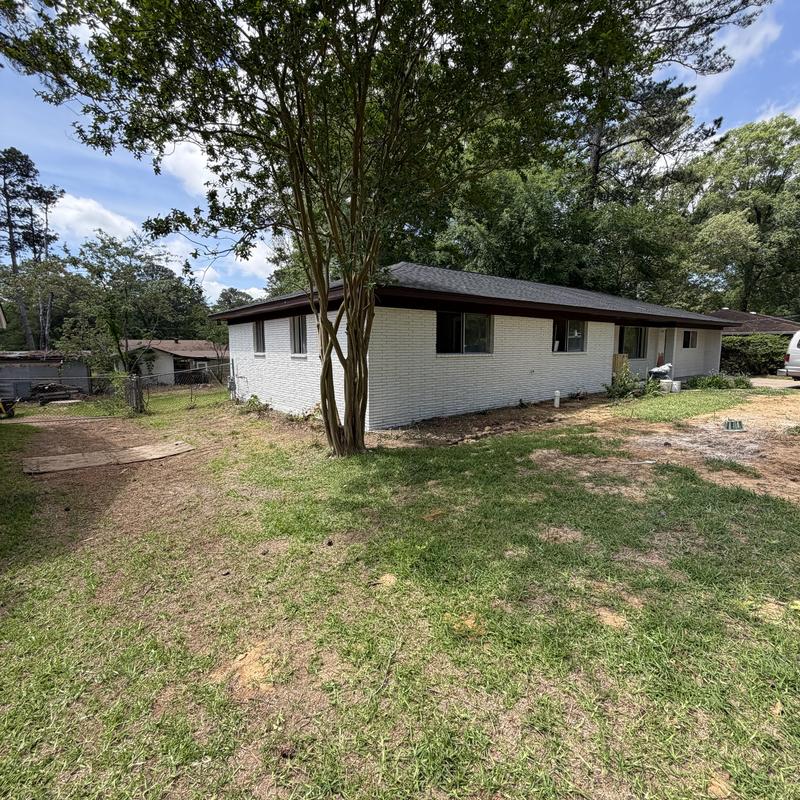 Brick exterior walls painted white on single-story home