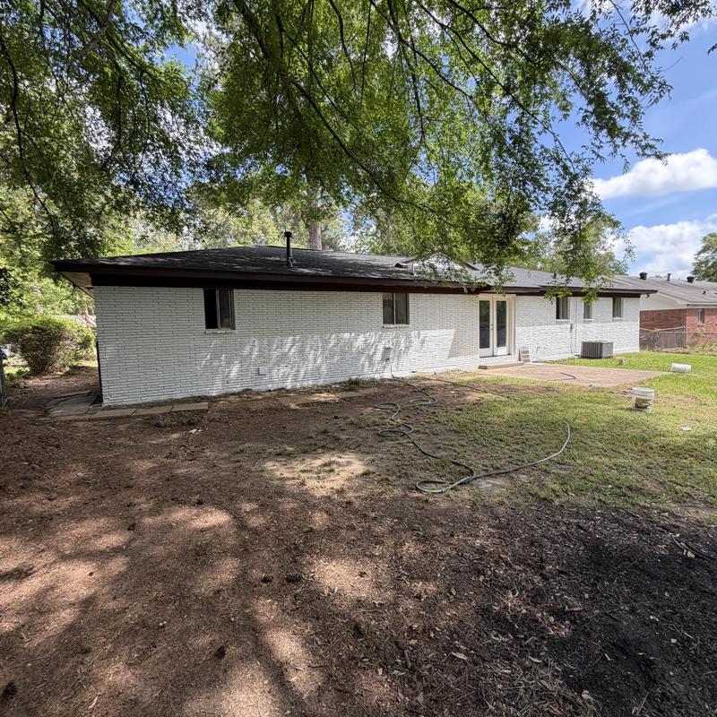 Exterior brick wall painted white on residential home