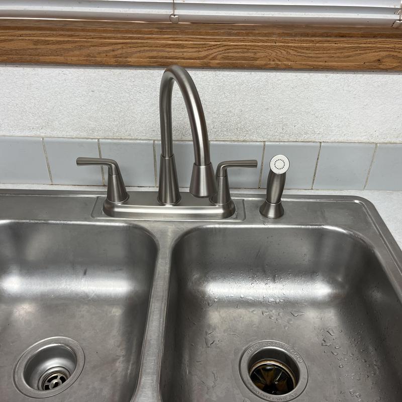 Kitchen faucet with soap dispenser on stainless steel sink