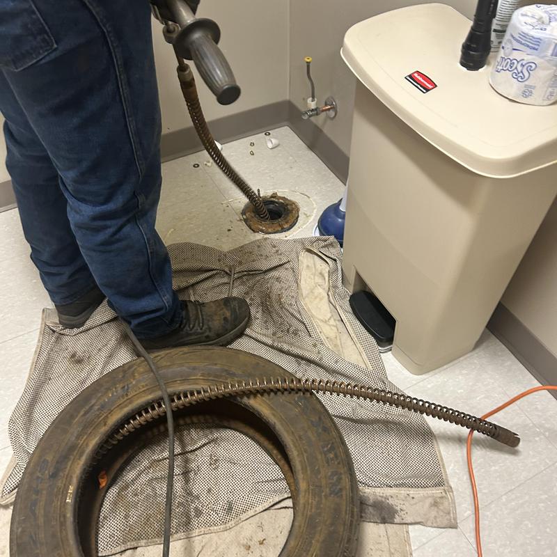 Main toilet drain line with plumbing snake cleaning Main toilet drain line with plumbing snake cleaning