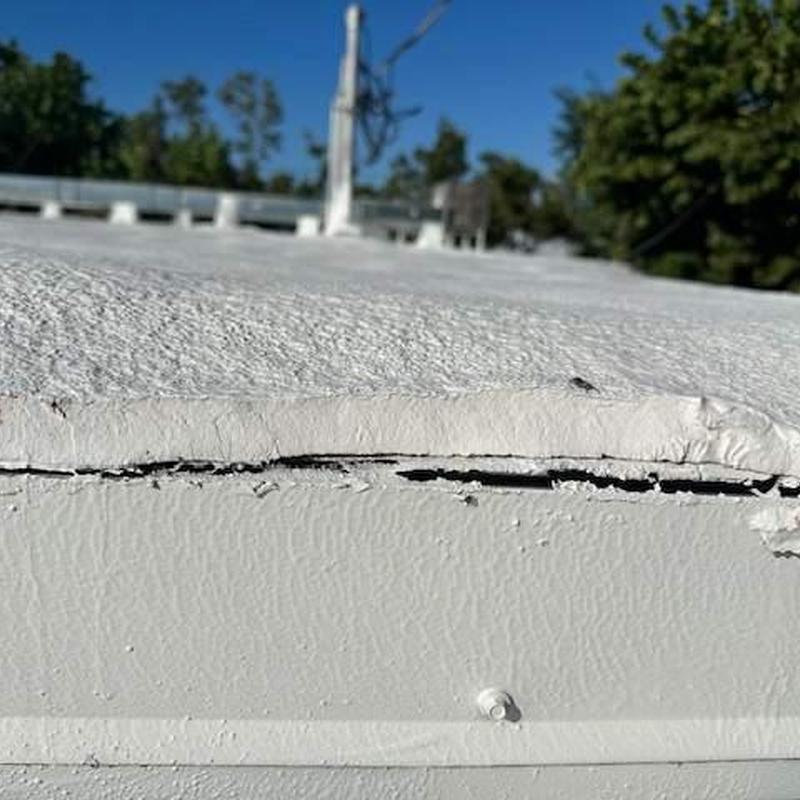SPF spray foam flat roof with elastomeric coating damage