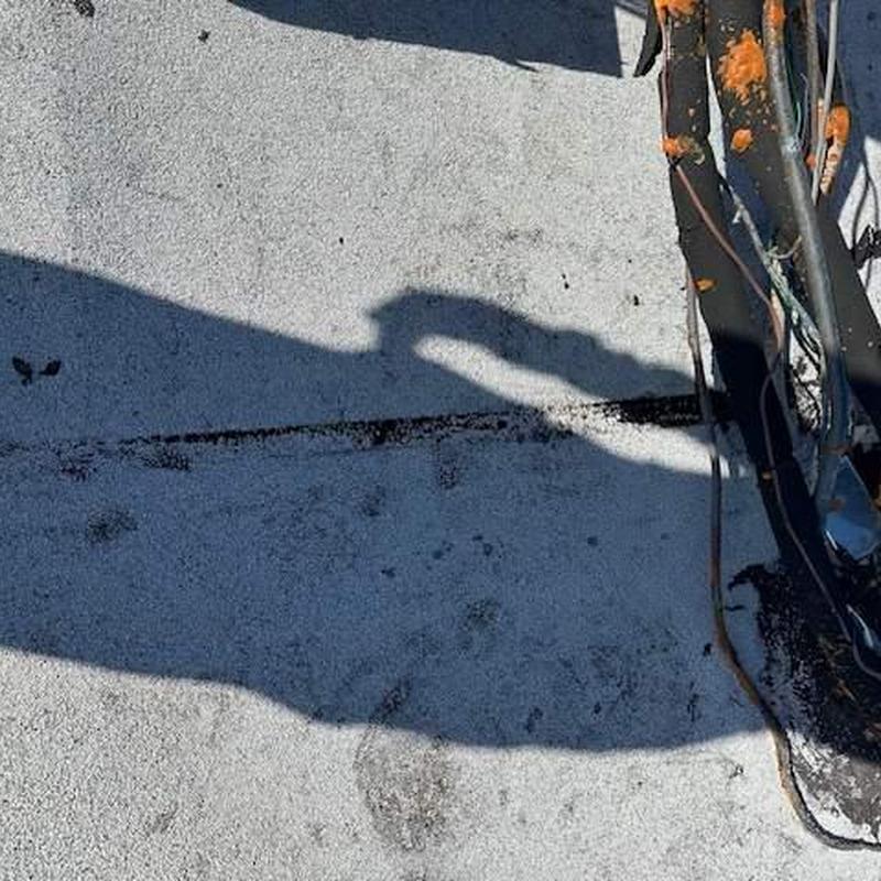 Flat roof with seam separation and granule loss