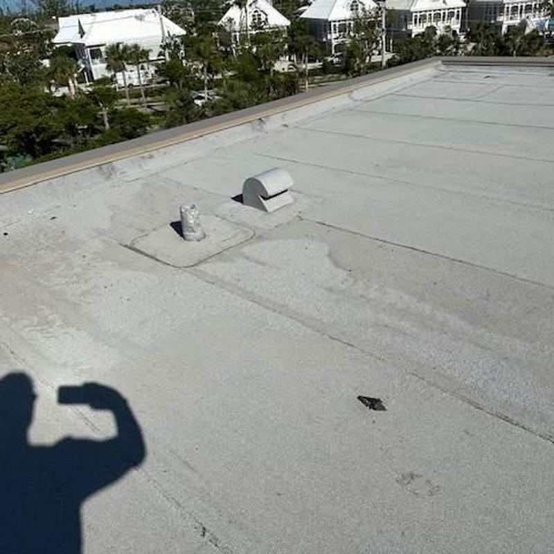 Flat commercial roof with seam separation and granule loss