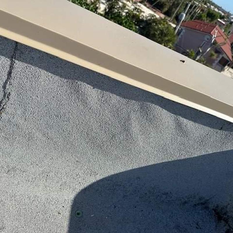 Commercial flat roof with granule loss and seam separation