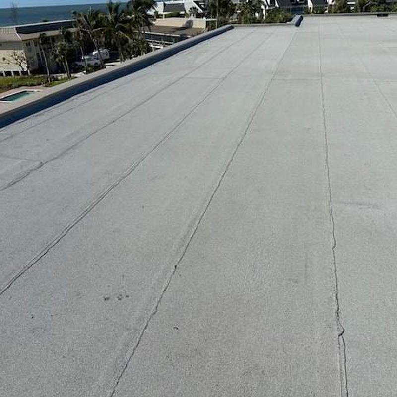 Commercial flat roof with seam separation and granule loss