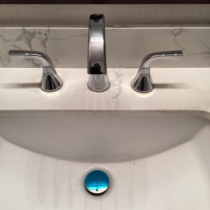 Wide-spread faucet installed on marble countertop sink