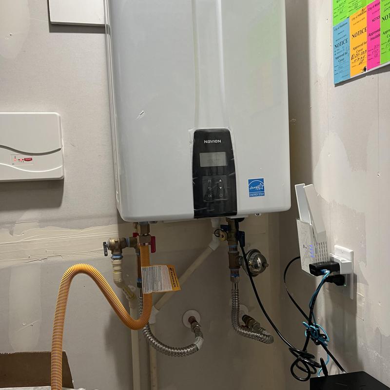 Tankless water heater installation with piping connections