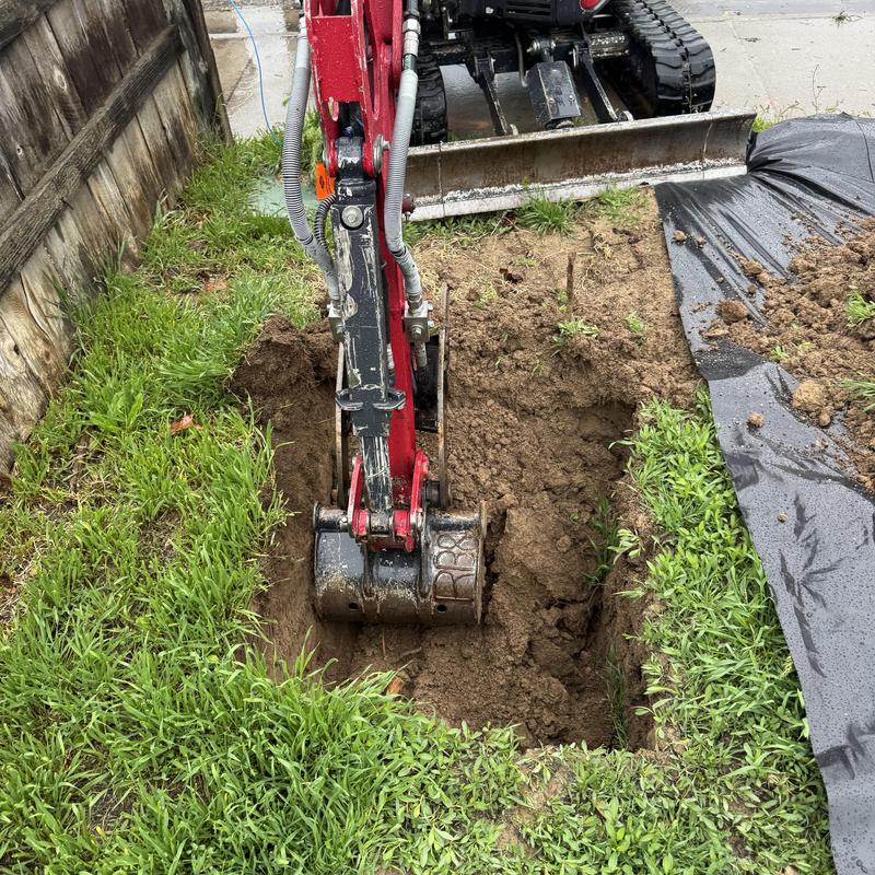 Copper water line excavation with mini excavator in yard