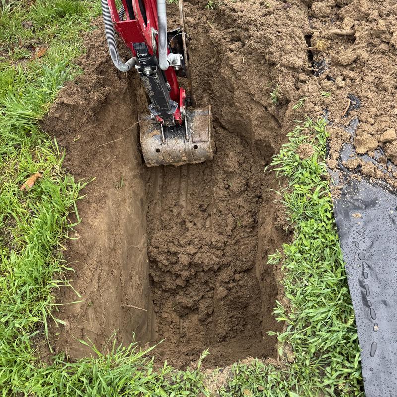 Copper water service line excavation with digger bucket