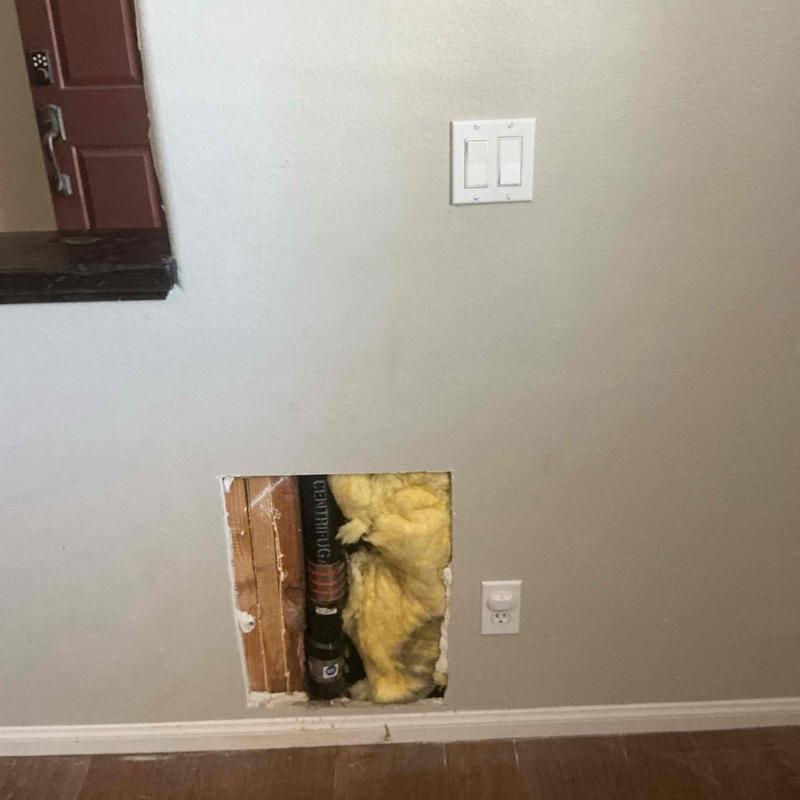 Sewer cleanout with ABS pipe and insulation exposed