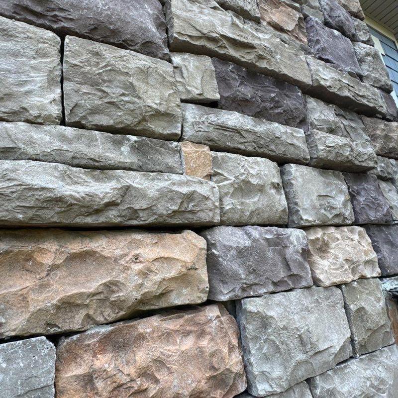 Stone veneer wall installation close-up with varied colors