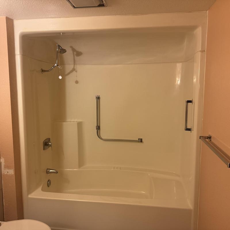 Fiberglass tubshower unit with grab bar installed