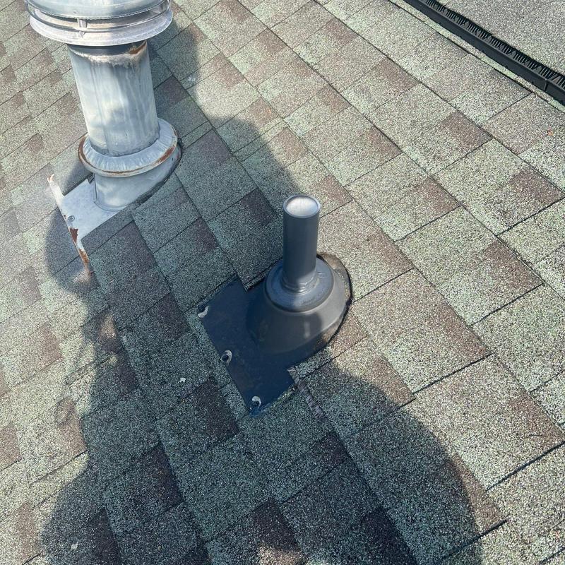 Roof vent flashing with hail damage on shingles
