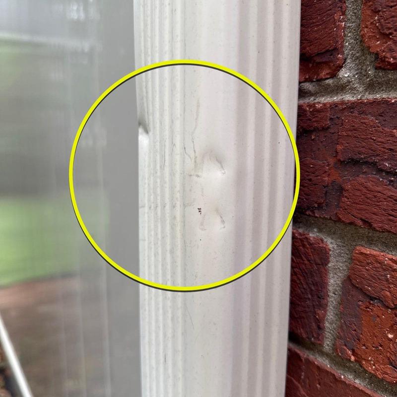 Vinyl door frame dent with scratch marks close-up