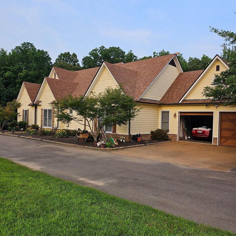 Owens Corning Oakridge Asphalt roofing system on yellow house