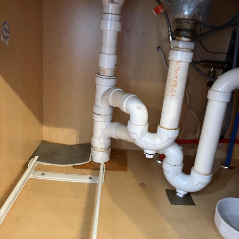 Kitchen sink drain pipes with wye and trap under cabinet