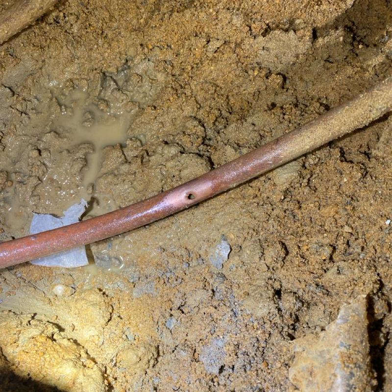 Copper water line with leak beneath concrete slab