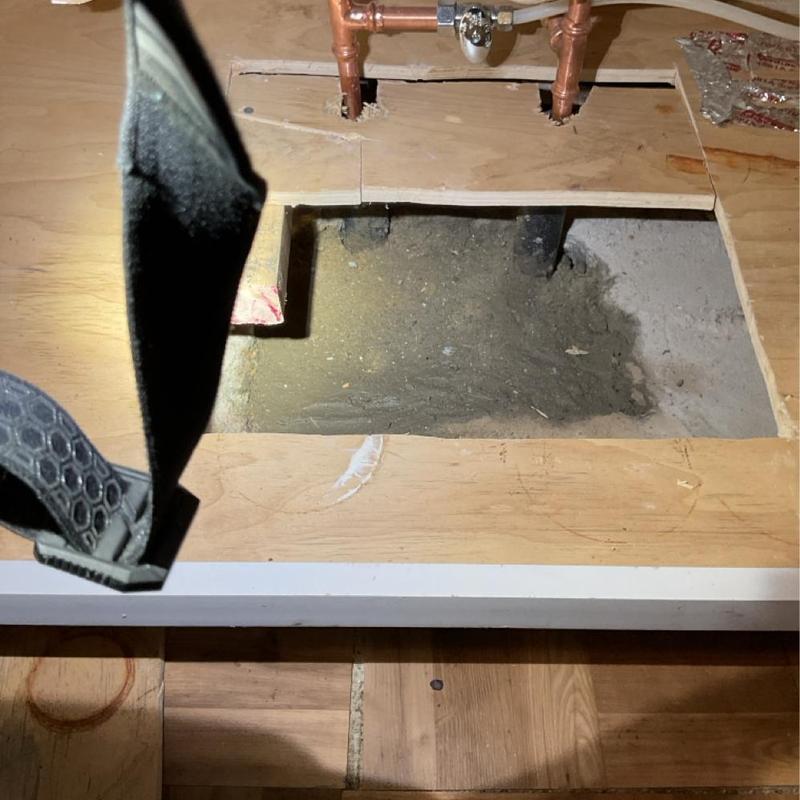 Copper water line beneath kitchen cabinet slab cutout