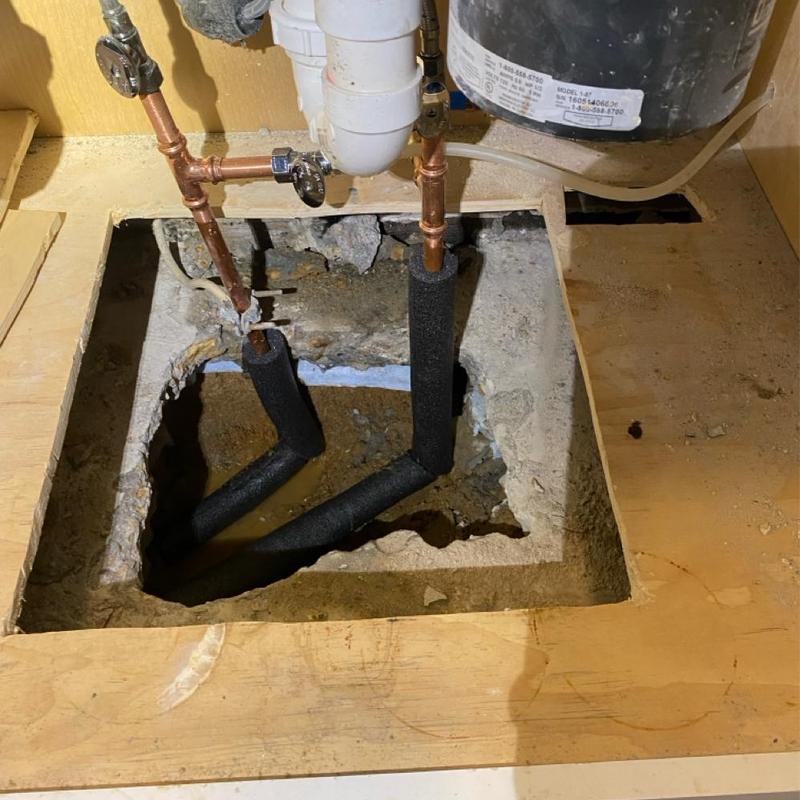 Copper water line under kitchen cabinet slab with repairs