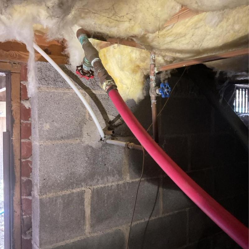 Main water line with valve and insulation in basement