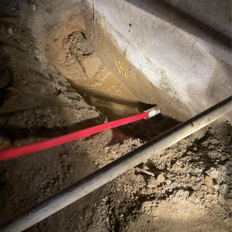 Main water line exposed in basement repair site
