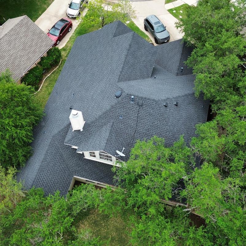 Charcoal GAF shingle roof with new gutters in Austin