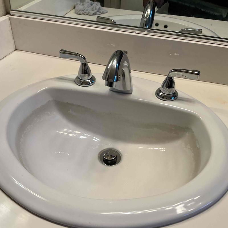 Delta faucet with handles installed on bathroom sink