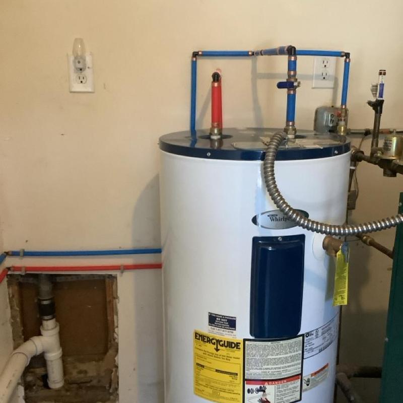 Water heater with new repiping and drain installation