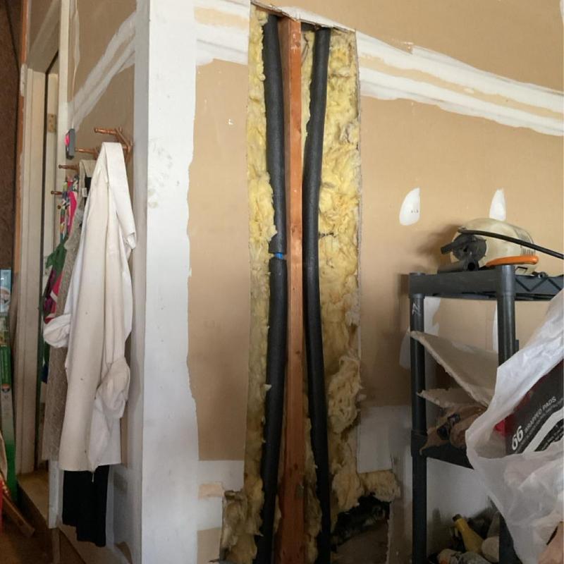 Gas water heater cold water lines inside wall with insulation