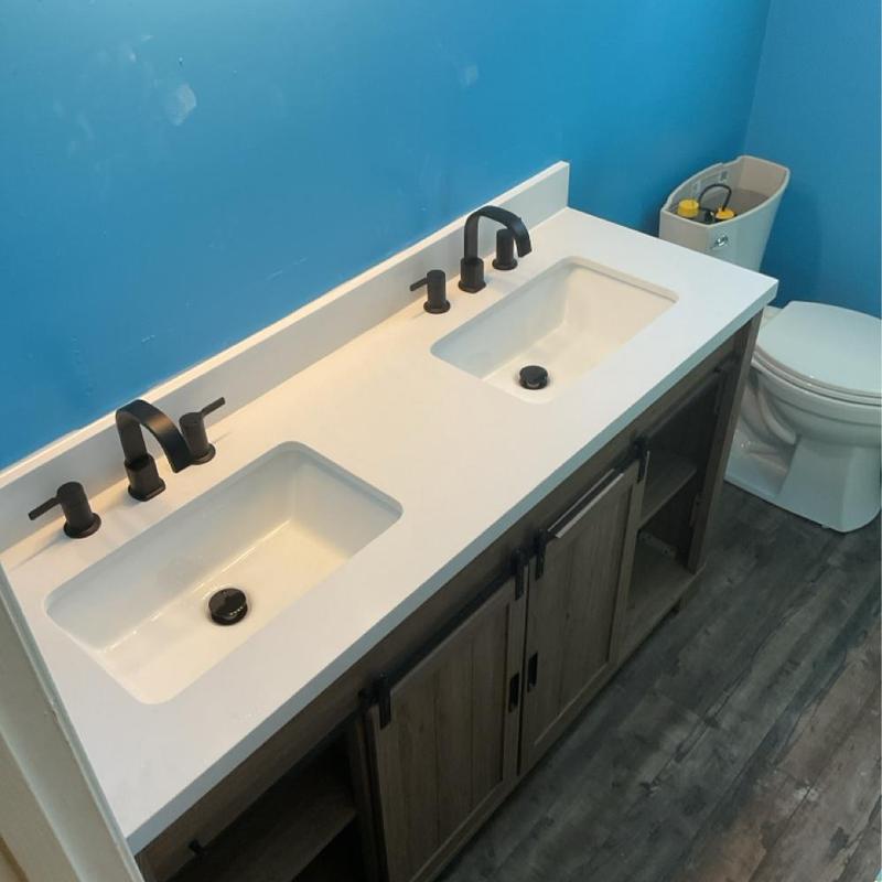 Double bowl lavatory sink with new faucets and vanity