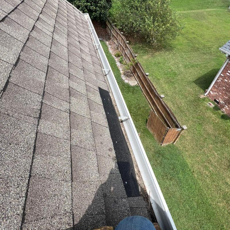 Asphalt shingles with hail damage near gutter system