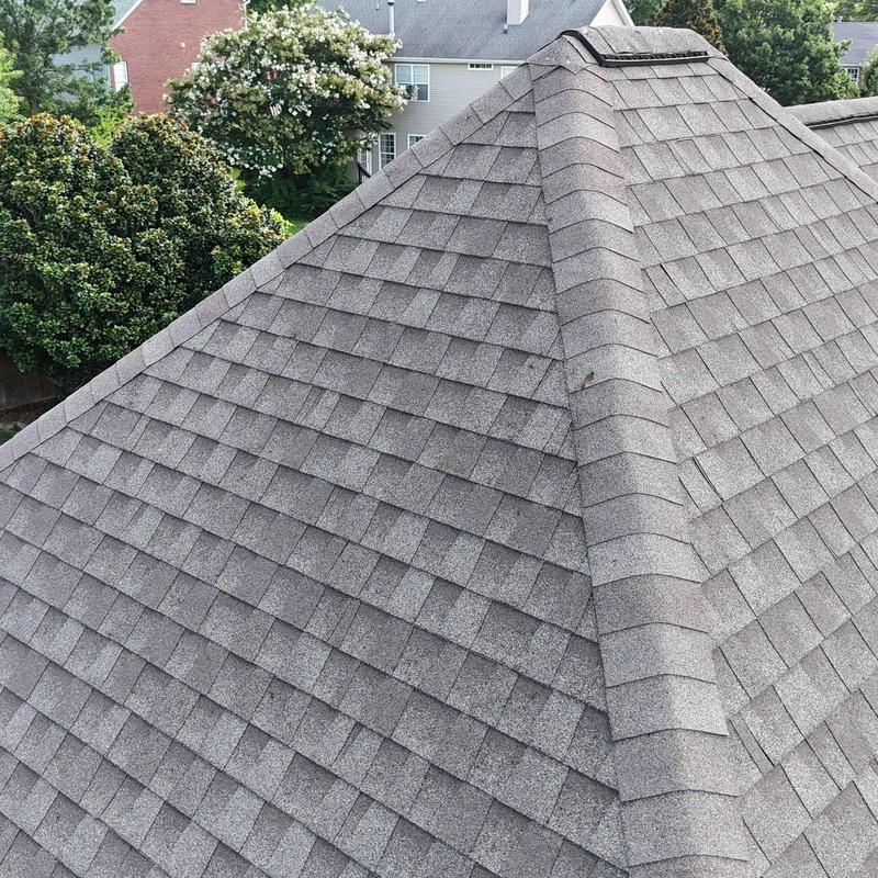 Asphalt shingle roof with ridge cap and vent repairs