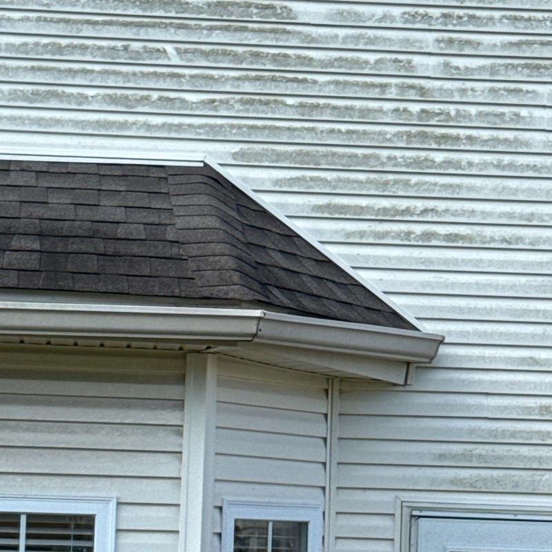 Asphalt shingle roof with hail damage on flashing