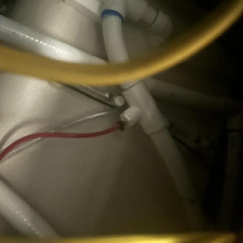 Electrical wiring near bathtub plumbing pipes under sink