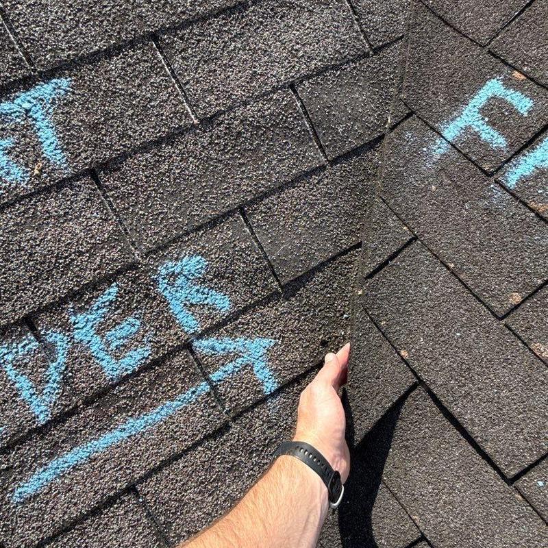 Asphalt roof shingles with hail damage inspection markings