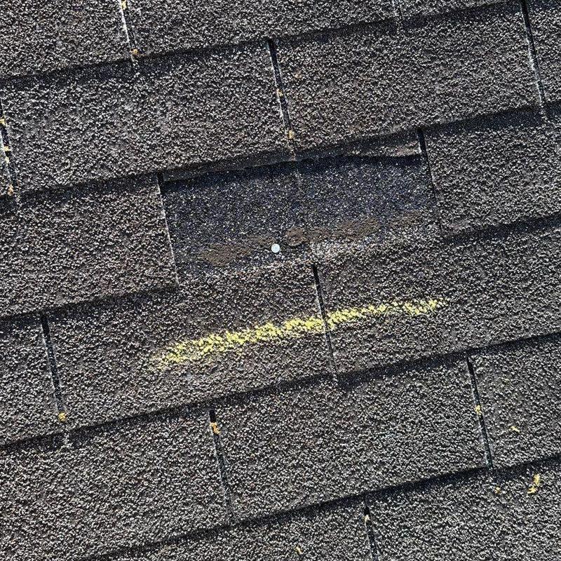 Asphalt roof shingles with hail damage and marking