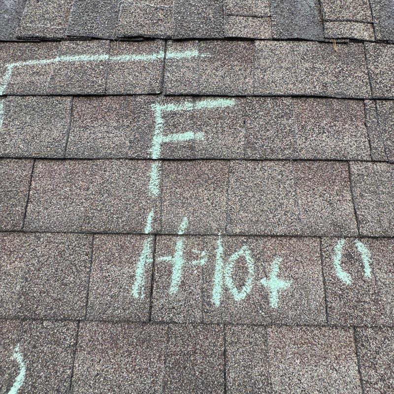 Roof shingles marked for hail damage inspection
