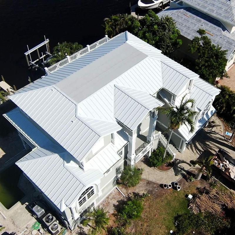 Aluminum standing seam roof installation on coastal home