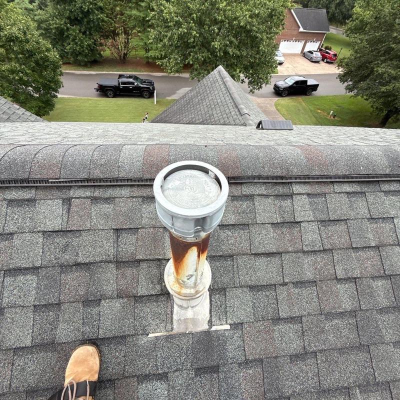 Roof vent pipe with rust on asphalt shingles